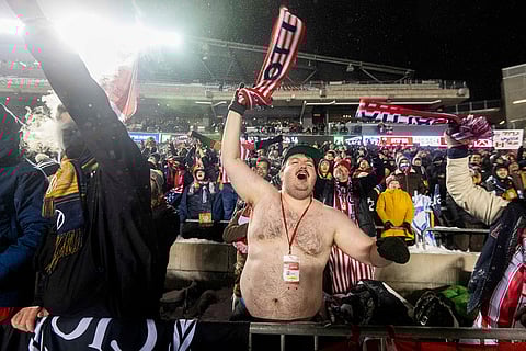 An Atletico Ottawa fan celebrates his teams' victory over over Cavalry FC following extra time during the Canadian Premier League finals soccer action in Ottawa.