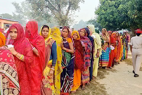 In this image, People wait in a queue to cast their votes during the second and final phase in the Bihar Assembly election, in Madhubani.