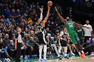| Photo: AP/LM Otero : Milwaukee Bucks forward Giannis Antetokounmpo (34) shoots a three-pointer against Dallas Mavericks center Moussa Cisse (30) during the second half of an NBA basketball game in Dallas.