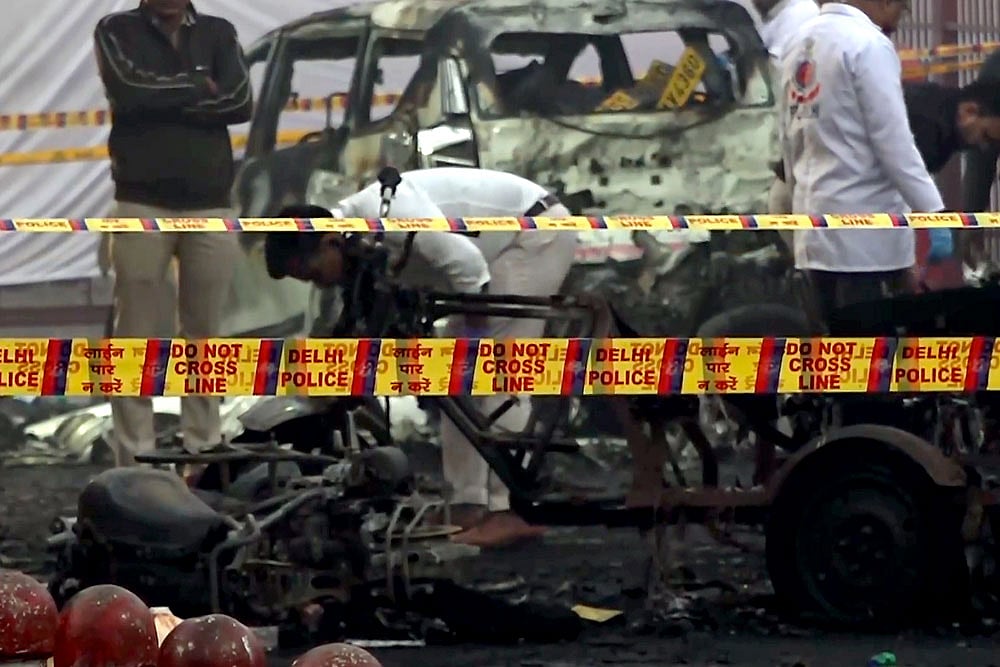 Charred remains of vehicles amid a cordoned off area following a blast that occurred near Red Fort Metro Station on Monday, killing at least nine people and gutting several vehicles, in New Delhi. - | Photo: PTI