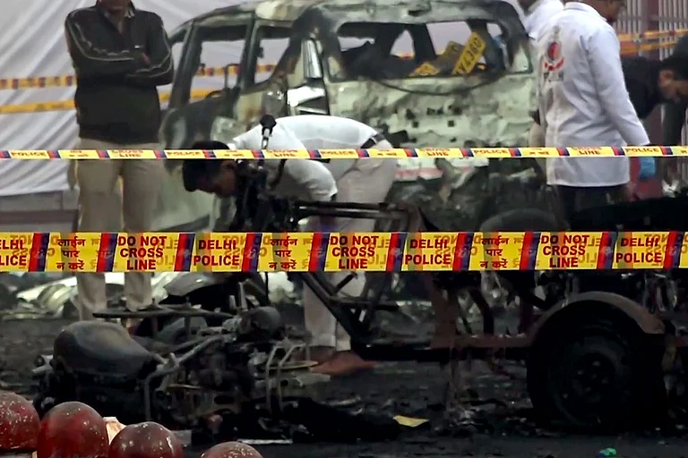 Charred remains of vehicles amid a cordoned off area following a blast that occurred near Red Fort Metro Station on Monday, killing at least nine people and gutting several vehicles, in New Delhi. - | Photo: PTI