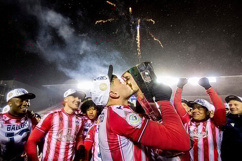Atletico Ottawa's Gabriel Mendes Antinoro (11) kisses the North Star Cup following Atletico Ottawa's victory over Cavalry FC in extra time during the Canadian Premier League finals soccer action in Ottawa.