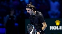 Lorenzo Musetti celebrates his win over Alex de Minaur at the ATP Finals