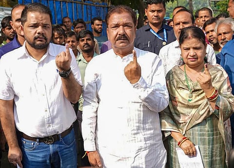 Bihar BJP President Dilip Jaiswal shows his ink-marked finger after casting a vote during the second and final phase of the state Assembly elections, in Kishanganj.