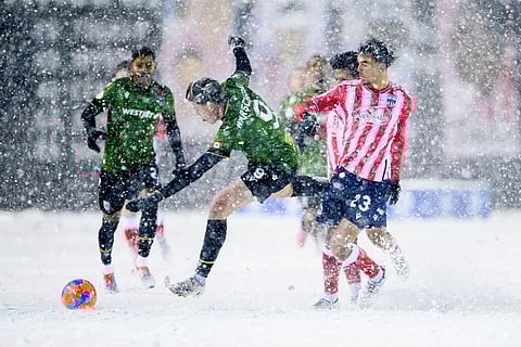 Cavalry FC's Tobias Warschewski (9) losses his footing as he attempts to gain possession of the ball from Atletico Ottawa's Noah Abatneh (23) during first half Canadian Premier League finals soccer action in Ottawa.