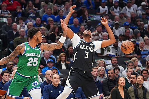 Dallas Mavericks forward P.J. Washington (25) knocks the ball loose against Milwaukee Bucks center Myles Turner (3) during the first half of an NBA basketball game in Dallas.