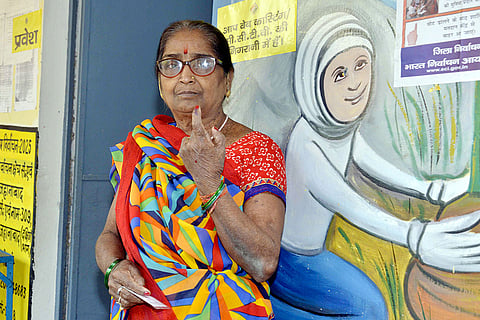 An elderly woman shows her ink-marked finger after casting her vote at a polling station during the second and final phase of the Bihar Assembly elections, in Jehanabad.