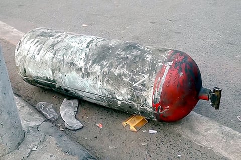 Charred remains of a cylinder lie on ground following a blast that occurred near Red Fort Metro Station on Monday, killing at least nine people and gutting several vehicles, in New Delhi.