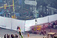 Red Fort Blast: Pulwama Doctor’s Mother Undergoes DNA Test, Victim Families Visit Maulana Azad Medical College | Photo: PTI/Kamal Kishore : Police personnel near an area covered with white cloth in view of the blast that occurred near Red Fort Metro Station on Monday, killing at least nine people and gutting several vehicles, in New Delhi.