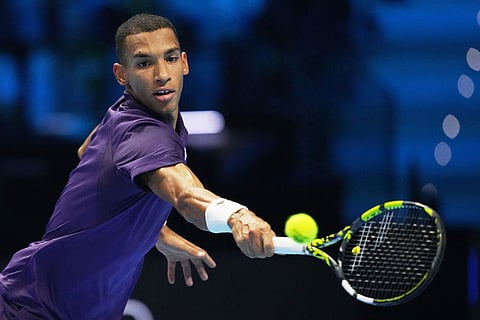 Canada's Felix Auger-Aliassime returns the ball to Italy's Jannik Sinner during their tennis match of the ATP World Tour Finals, in Turin, Italy.
