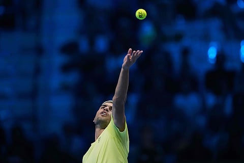 Spain's Carlos Alcaraz serves the ball to Australia's Alex de Minaur during their singles tennis match of the ATP World Tour Finals, in Turin, Italy.