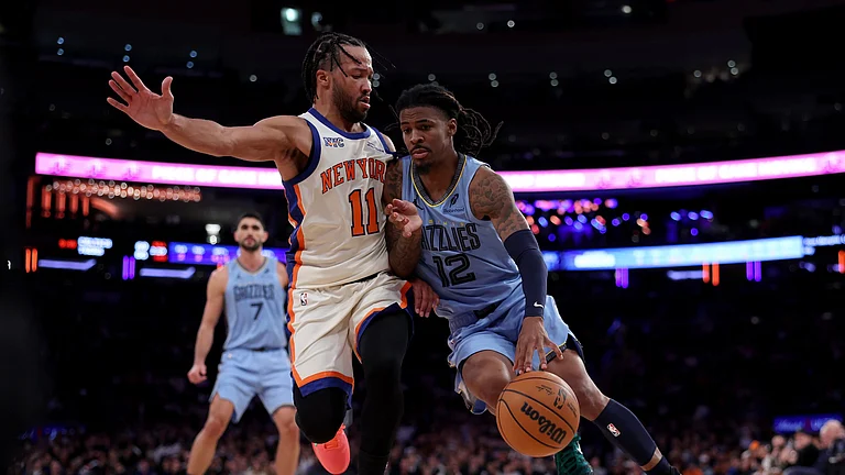 Ja Morant #12 of the Memphis Grizzlies heads for the net as Jalen Brunson #11 of the New York Knicks defends in the fourth quarter at Madison Square Garden on November 11, 2025 in New York City. The New York Knicks defeated the Memphis Grizzlies 133-120. - null