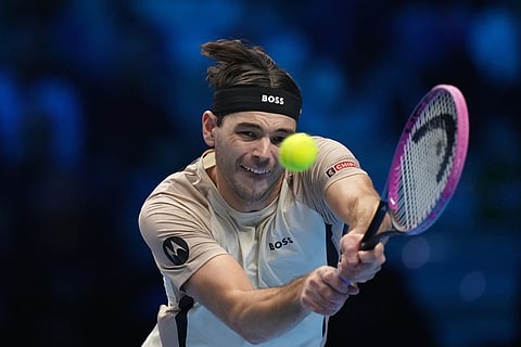 United States' Taylor Fritz returns the ball to Spain's Carlos Alcaraz during their tennis match of the ATP World Tour Finals, in Turin, Italy.