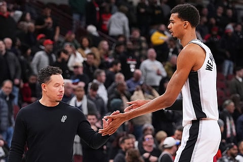 San Antonio Spurs head coach Mitch Johnson, left, celebrates with forward Victor Wembanyama during the second half of an NBA basketball game against the Chicago Bulls in Chicago.