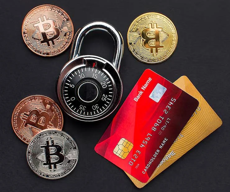 Bitcoin coins, credit cards, and a padlock showing digital finance security