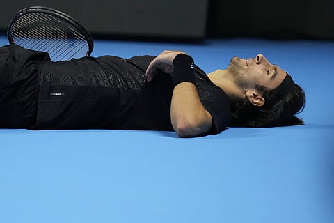 Italy's Lorenzo Musetti reacts after losing a point against Australia's Alex de Minaur during their tennis match of the ATP World Tour Finals, in Turin, Italy.