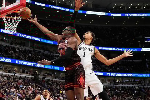 Chicago Bulls forward Jalen Smith, left, drives to the basket past San Antonio Spurs forward Victor Wembanyama during the second half of an NBA basketball game in Chicago.