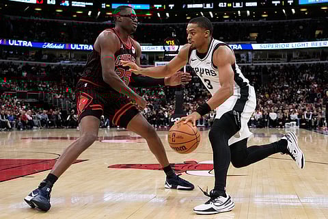 San Antonio Spurs forward Keldon Johnson, right, drives against Chicago Bulls forward Jalen Smith during the second half of an NBA basketball game in Chicago.