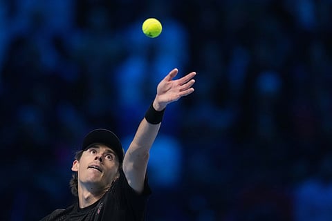 Australia's Alex de Minaur serves the ball to Italy's Lorenzo Musetti during their tennis match of the ATP World Tour Finals, in Turin, Italy.