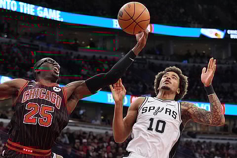 Chicago Bulls forward Jalen Smith, left, rebounds a ball against San Antonio Spurs forward Jeremy Sochan during the first half of an NBA basketball game in Chicago.