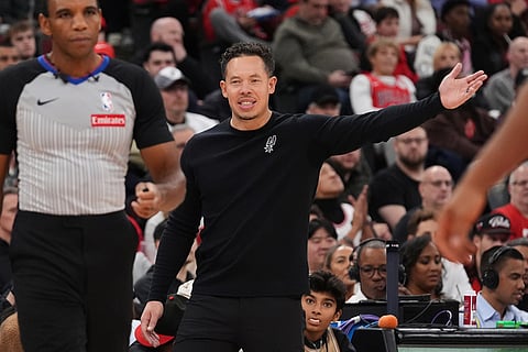 San Antonio Spurs head coach Mitch Johnson reacts to a call during the second half of an NBA basketball game against the Chicago Bulls in Chicago.