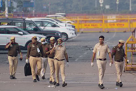 Police personnel search for evidence in the premises of Sri Digambar Jain Lal temple in the aftermath of a blast in the area, opposite Red Fort, in New Delhi.
