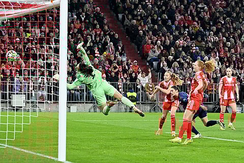 Arsenal's Emily Fox, third from right, scores the opening goal past Bayern's goalkeeper Maria Luisa Grohs during the women's Champions League opening phase soccer match between FC Bayern Munich and Arsenal FC in Munich, Germany.