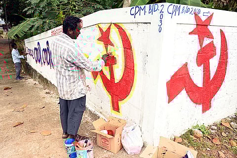 Artists paint the LDF symbol on a wall as part of preparations for the upcoming Kerala local body elections, in Thiruvananthapuram.