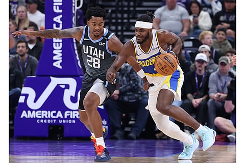 Indiana Pacers forward Jarace Walker, right, dribbles against Utah Jazz forward Brice Sensabaugh (28) during the second half of an NBA basketball game in Salt Lake City. 