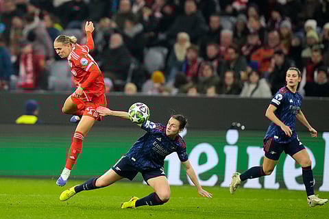 Arsenal's Lotte Wubben-Moy vies for the ball with Bayern's Klara Buehl, left, during the women's Champions League opening phase soccer match between FC Bayern Munich and Arsenal FC in Munich, Germany.