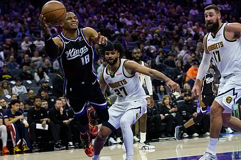 Sacramento Kings guard Russell Westbrook (18) leaps to keep the ball in bounds during the second half of an NBA basketball game against the Denver Nuggets in Sacramento, California.