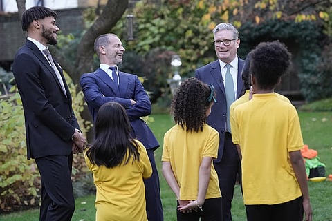 Britain's Prime Minister Sir Keir Starmer, right, welcomes UEFA President Aleksander Ceferin, center, and footballer Tyrone Mings and children from John Keble CofE Primary School to number 10 Downing Street to mark the launch of the Euro 2028 soccer tournament, in London.