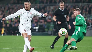 AP/Peter Morrison : Jack Taylor, right, tries to block a shot from Portugal's Cristiano Ronaldo during a World Cup 2026 group F qualifying soccer match.