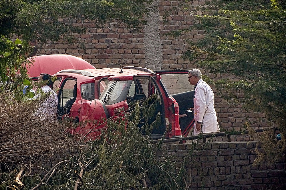Central Forensic Science Laboratory (CFSL) officials at the site after a red Ford EcoSport car suspected to be linked to the Delhi Red Fort blast case was traced and seized in Faridabad district's Khandawali. - | Photo: PTI
