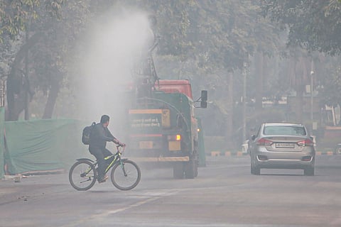 An anti-smog gun sprays water droplets to curb air pollution, in New Delhi. The city's air quality remained in the 'severe' category for the third consecutive day, according to officials.