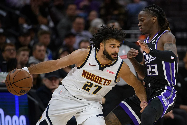 Denver Nuggets guard Jamal Murray (27) drives past Sacramento Kings guard Keon Ellis (23) during the second half of an NBA basketball game in Sacramento, California. - | Photo: AP/Randall Benton