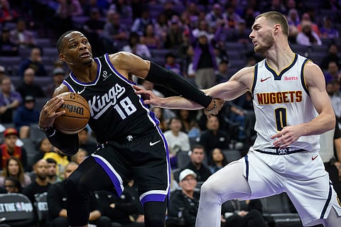 Sacramento Kings guard Russell Westbrook (18) is guarded by Denver Nuggets guard Christian Braun (0) during the second half of an NBA basketball game in Sacramento, California.