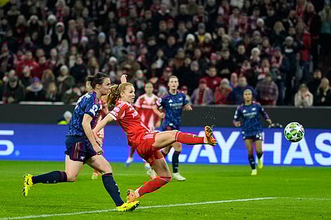 Bayern's Glodis Viggosdottir, center, scores her side's third goal during the women's Champions League opening phase soccer match between FC Bayern Munich and Arsenal FC in Munich, Germany.