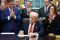 Longest U.S. Shutdown Ends As Congress Approves Deal (AP Photo/Jacquelyn Martin) : President Donald Trump signs the funding bill to reopen the government, in the Oval Office of the White House, Wednesday, Nov. 12, 2025, in Washington.