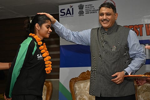 Sports secretary Hari Ranjan Rao with India's Tokyo Deaflympics flagbearer Jerlin Jayaratchagan.