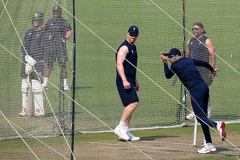 Kesav Maharaj, bowls at net as Simon Harmer looks on during the practice session ahead of the first test match between India and South Africa, in Kolkata.