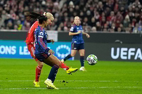 Bayern's Pernille Harder, left, scores her side's second goal during the women's Champions League opening phase soccer match between FC Bayern Munich and Arsenal FC in Munich, Germany.