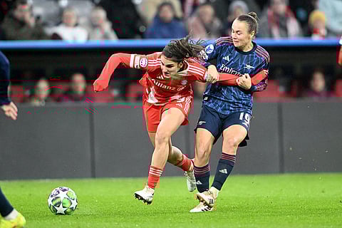 Munich's Jovana Damnjanovic, left, and Arsenal's Caitlin Foord battle for the ball during women's Champions League soccer match between Bayern Munich and WFC Arsenal in Munich, Germany.