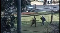 | Photo: AP/AAJ via APTN : File photo of two gunmen seen near a vehicle in Lahore, Pakistan, Tuesday, March 3, 2009, in this image taken from television.
