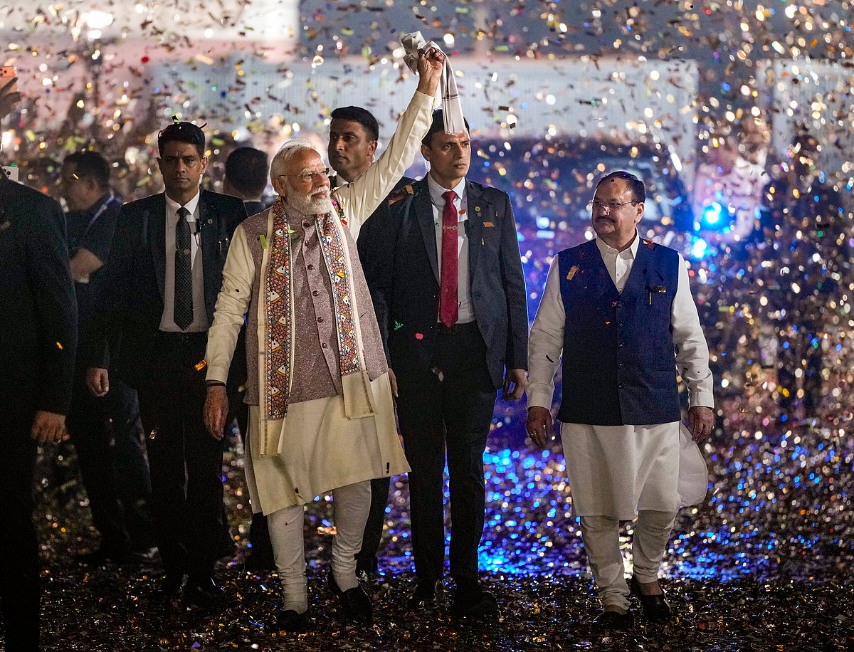 Ravi Choudhary : Prime Minister Narendra Modi waves a  as he arrives during the celebration of NDA victory in the Bihar Assembly elections, at BJP headquarters, in New Delhi, Friday, Nov. 14, 2025. Union Health Minister and BJP National President JP Nadda is also seen.