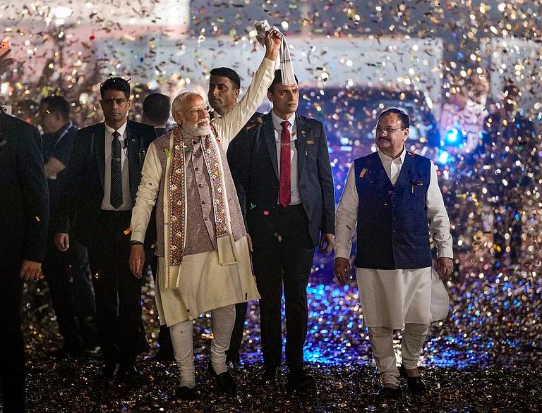 Prime Minister Narendra Modi waves a as he arrives during the celebration of NDA victory in the Bihar Assembly elections, at BJP headquarters, in New Delhi, Friday, Nov. 14, 2025. Union Health Minister and BJP National President JP Nadda is also seen. - Ravi Choudhary
