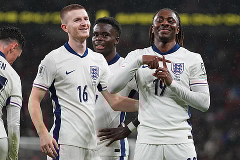England's Adam Wharton, left, and Eberechi Ezecelebrate after a goal during a World Cup qualifier group K soccer match between Serbia and England in London.
