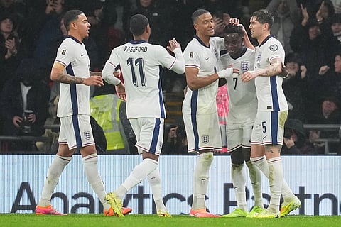 England players celebrate after a goal during a World Cup qualifier group K soccer match between Serbia and England in London.
