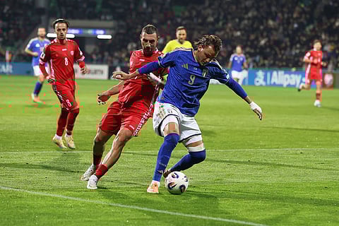 Italy's Mateo Retegui, right, challenges for the ball with Moldova's Artur Ionita during a group 1, World Cup qualifier soccer match between Moldova and Italy in Chisinau, Moldova.