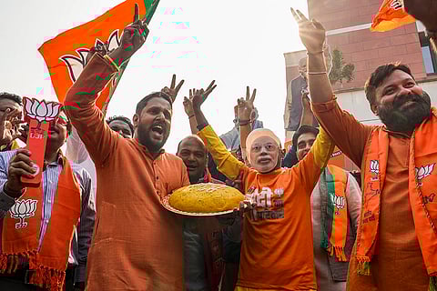 BJP workers celebrate a lead in the Bihar Assembly elections as early trends indicate the NDA crossing the majority mark, at the BJP Headquarters in New Delhi.